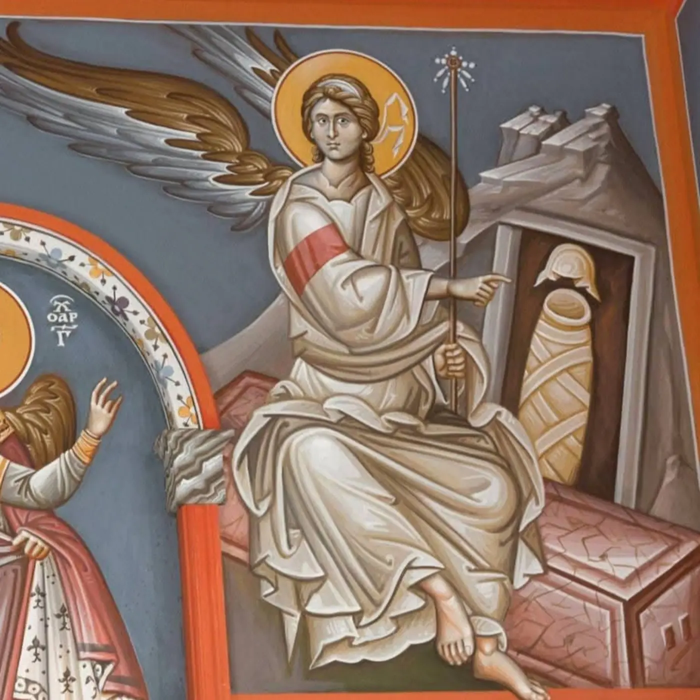 An angel sits beside the empty tomb in a painted Resurrection scene