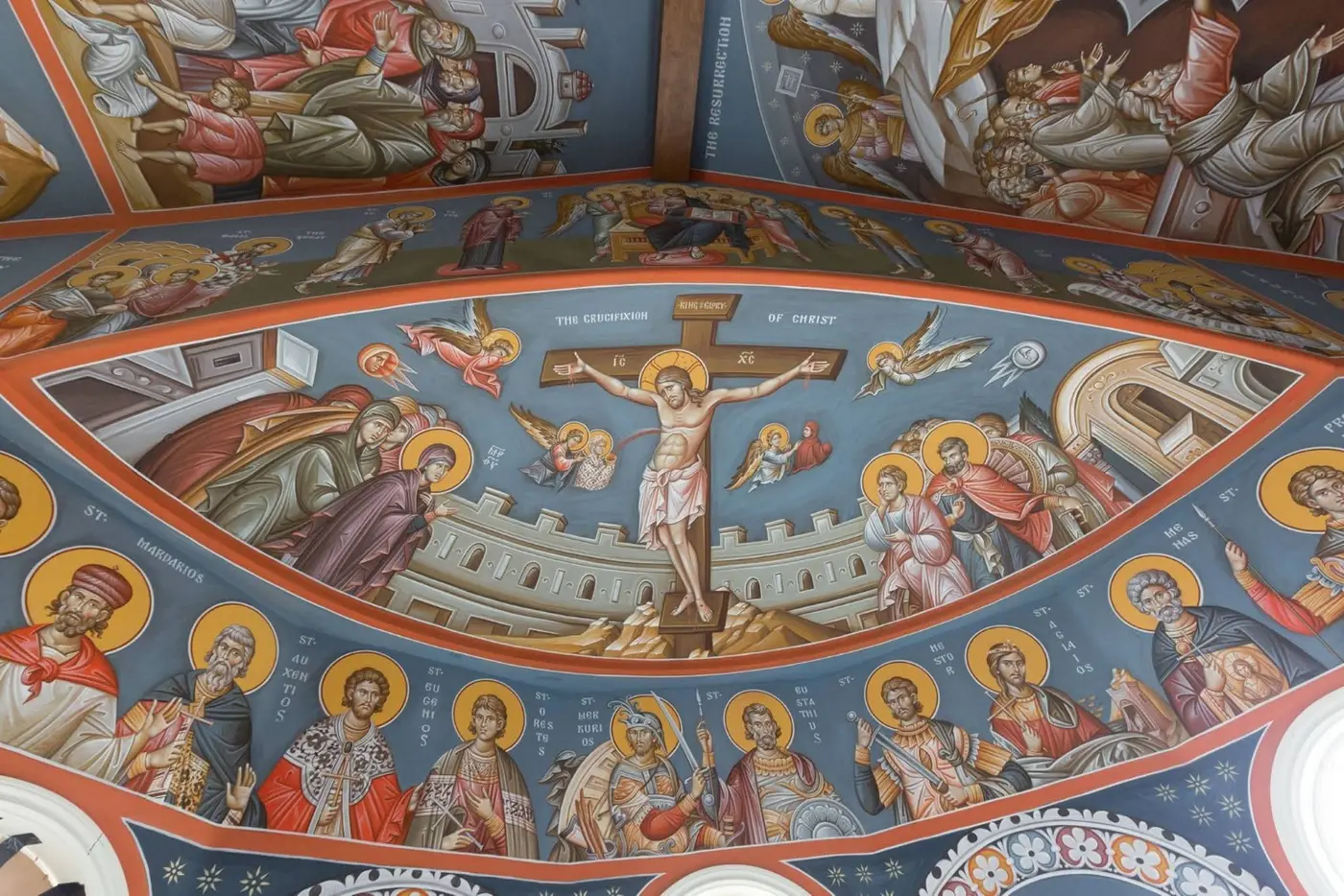 Expansive Orthodox frescoes across a painted vault, showing the Crucifixion and saints